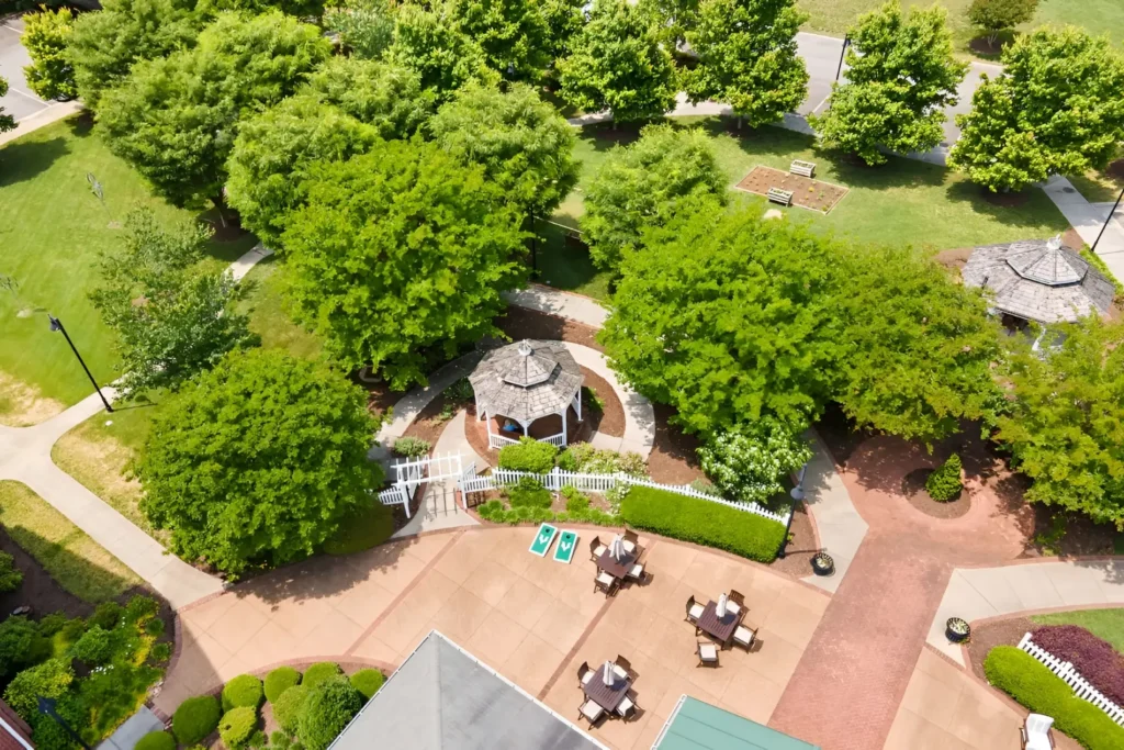 Aerial view of a landscaped courtyard with shrubs, pathways and patio tables